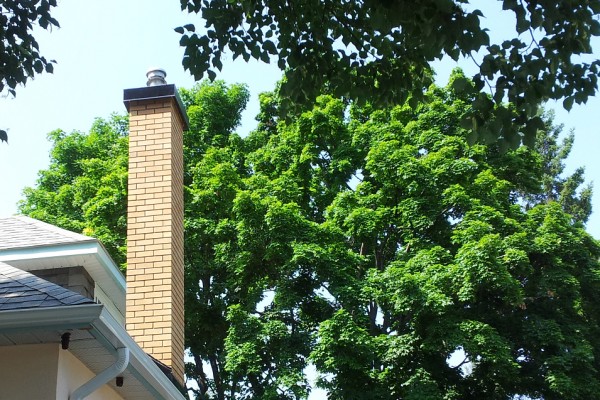 Brick chimney with metal cap