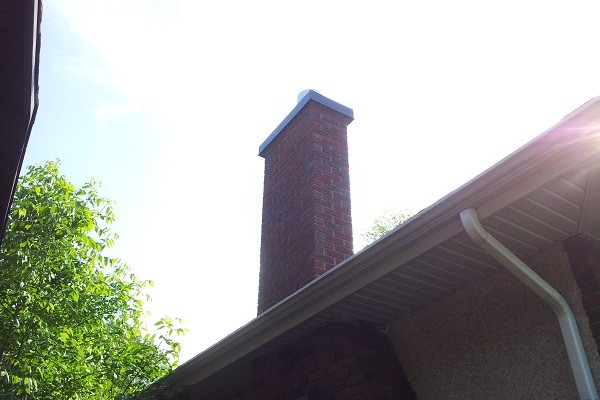 Brick chimney with metal cap
